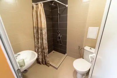 a bathroom with a shower and a toilet and a sink at GGeorgi Sarafovo in Burgas City