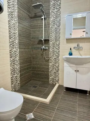 a bathroom with a shower and a toilet and a sink at Елскер in Tsarevo