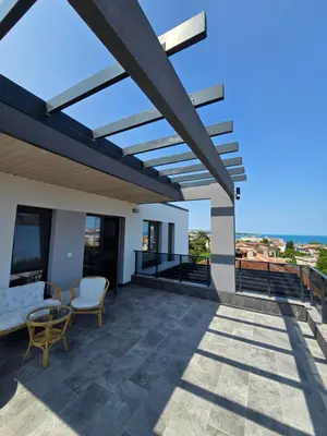 a patio with a view of the ocean at Къща Холидей Обзор in Obzor