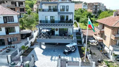an aerial view of a house with a flag at Къща Холидей Обзор in Obzor