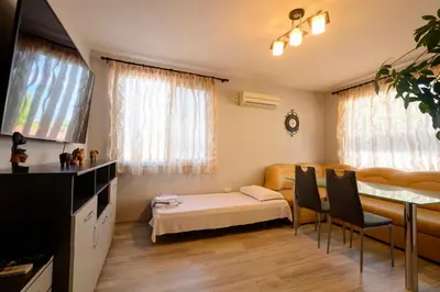 a living room with a table and a dining room at Apartment Yanevi in Lozenets