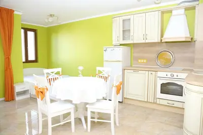 a dining room with a white table and chairs at Flora Deluxe Studio in Burgas City