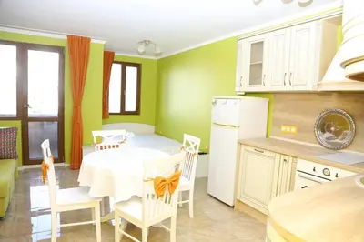 a kitchen with a table and chairs in a room at Flora Deluxe Studio in Burgas City