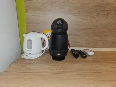 a coffee maker sitting on top of a wooden floor at Flora Deluxe Studio in Burgas City