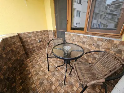 a table and two chairs and a table and a window at Flora Deluxe Studio in Burgas City