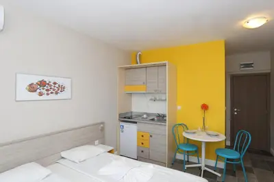 a bedroom with a bed and a table and chairs at Sunny Residence complex in Sunny Beach