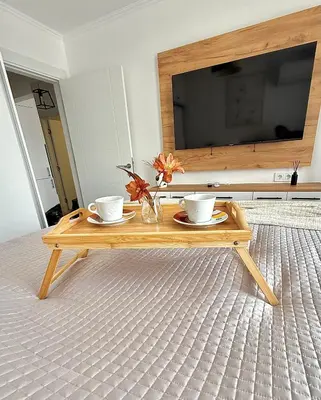 a coffee table with two cups and a television at Polarstar Apartment in Sveti Vlas
