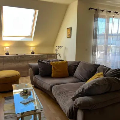 a living room with a couch and a table at Морска Идилия in Burgas City