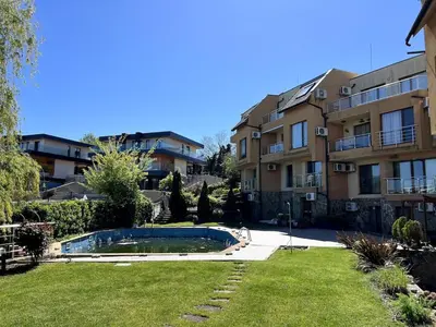 an apartment complex with a swimming pool in a yard at Морска Идилия in Burgas City