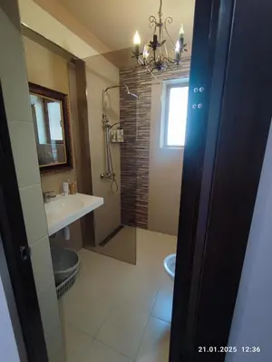 a bathroom with a sink and a toilet and a mirror at Central View Burgas in Burgas City