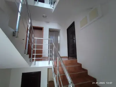 a staircase in a house with a metal railing at Central View Burgas in Burgas City