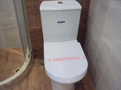 a bathroom with a toilet with a sticker on it at Apartment Alyosha in Burgas City