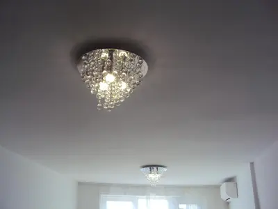 a chandelier hanging from a ceiling in a room at Apartment Alyosha in Burgas City