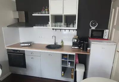 a small kitchen with a sink and a microwave at AT Home in Burgas City