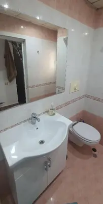 a bathroom with a white sink and a toilet at AT Home in Burgas City