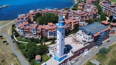 an aerial view of a building with a clock tower at Ваканционен Апартамент in Aheloy