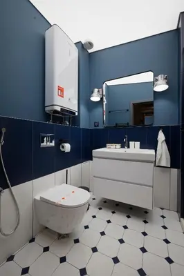 a blue bathroom with a toilet and a sink at Tsaribrod Design Apartments in Varna City
