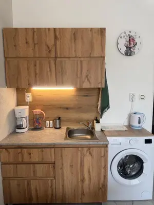 a kitchen with a sink and a washing machine at Sol e Mar Private Apartment in Sunny Beach