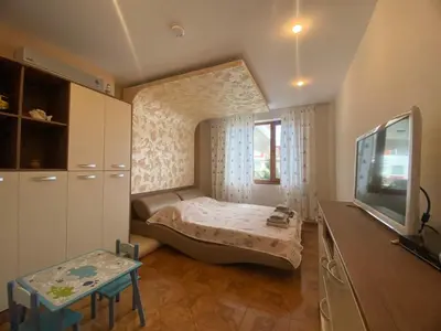 a small bedroom with a bed and a tv at Robinzon Beach 3BD Lux apartment by Flat Mаnager in Elenite