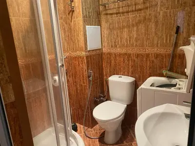 a bathroom with a toilet and a shower and a sink at Robinzon Beach 3BD Lux apartment by Flat Mаnager in Elenite