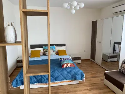 a bedroom with a bunk bed with a ladder at Зора-Обзор in Obzor