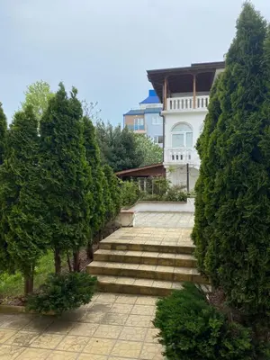 a set of stairs in front of a house with trees at Зора-Обзор in Obzor