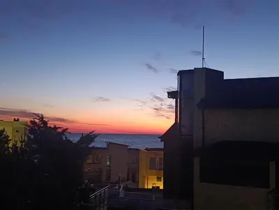 a sunset over the ocean in a city with buildings at Via Sunride 2 - Maisonette Apartment by the sea in Sozopol