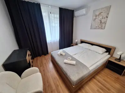 a bedroom with a bed with two towels on it at Arena I by the Sea in Sveti Vlas