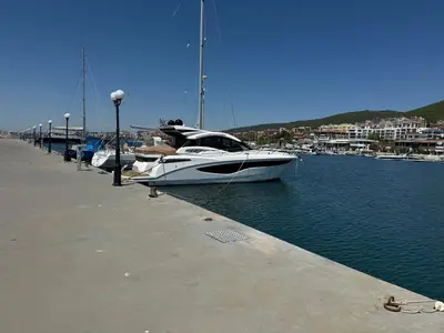 a boat is docked at a dock in the water at Arena I by the Sea in Sveti Vlas