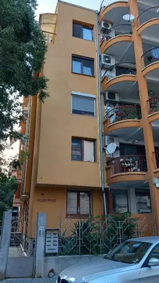 a building with a car parked in front of it at Апартамент Плажен рай in Burgas City