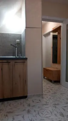 a kitchen with a sink and a mirror at Апартамент Плажен рай in Burgas City