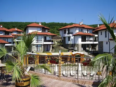 a group of buildings with palm trees in front of them at Dream apartment in sunny beach in Kosharitsa
