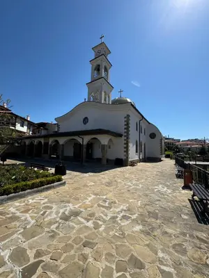 a large white building with a clock tower at Diamond by the Sea in Sveti Vlas