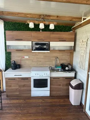 a kitchen with a sink and a stove at Каравана Кътче от Рая in Tsarevo