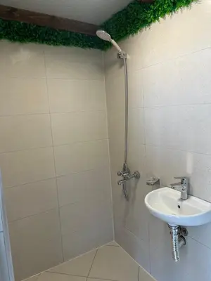 a bathroom with a sink and a shower at Каравана Кътче От Рая in Tsarevo