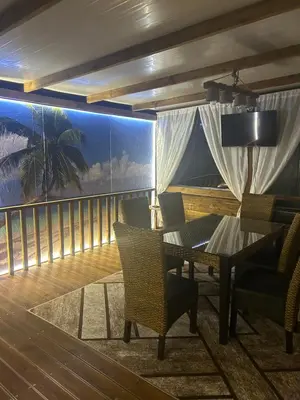 a room with a balcony with a table and chairs at Каравана Кътче От Рая in Tsarevo
