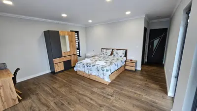 a bedroom with a bed and a television in it at Холидей Обзор-Стая in Obzor