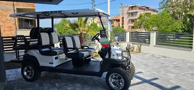 a golf cart is parked on a brick street at Холидей Обзор-Стая in Obzor
