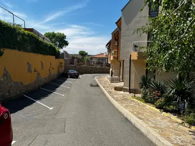 an empty street with a car parked next to a building at Paradise apartment Sozopol in Sozopol