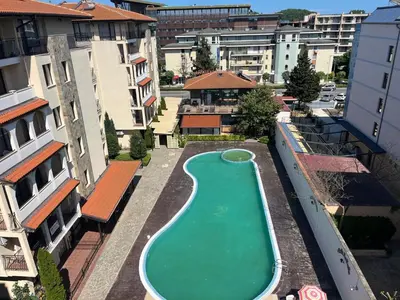 an empty swimming pool in the middle of a city at Rose Village Apartment in Sunny Beach