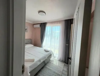 a bedroom with a bed and a large window at Sofi's Harmony in Burgas City