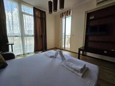 a bedroom with a bed with two towels on it at Sea View Dune Apartment in Sunny Beach