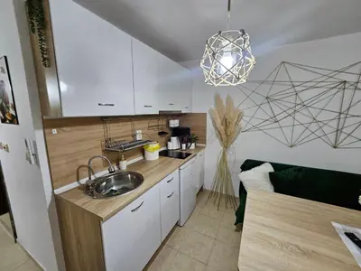 a kitchen with white cabinets and a sink at Tropical Chic for Two, Basement Studio Escape by Flat Mаnager in Ravda