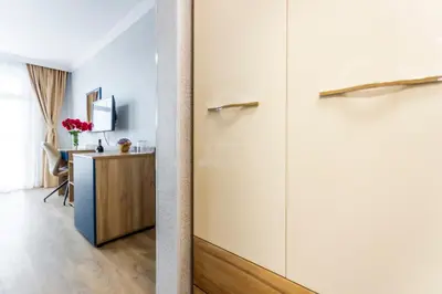 a hallway with a closet and a desk in a room at Hotel Laguna SPA in Sveti Vlas