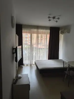 a bedroom with a bed and a large window at Apartment Sunny View Central in Sunny Beach