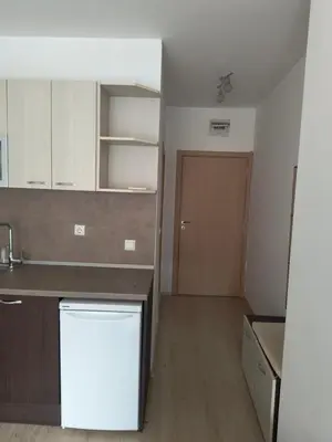 a kitchen with a sink and a refrigerator and a door at Apartment Sunny View Central in Sunny Beach