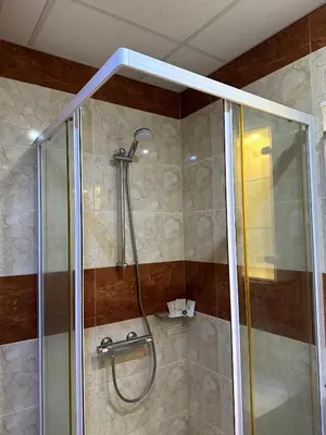 a shower with a glass door in a bathroom at The Sunny Spot in Sunny Beach