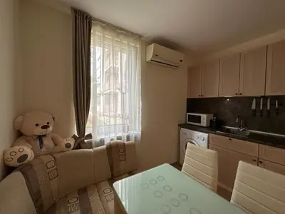 a living room with a teddy bear sitting on a couch at The Sunny Spot in Sunny Beach