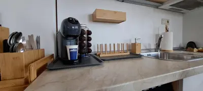 a kitchen counter with a coffee maker next to a sink at Royal sun in Sunny Beach