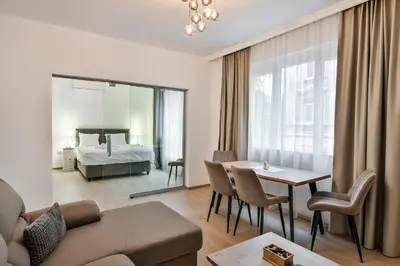 a living room with a couch and a bed and a table at City center 2BR next to Sea in Varna City